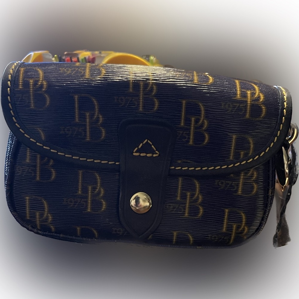 NWT Dooney & Bourke wristlet. Navy with gold signature print
